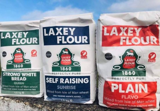 Three bags of Laxey Flour: Strong White Bread, Self Raising Sunrise, and Plain.